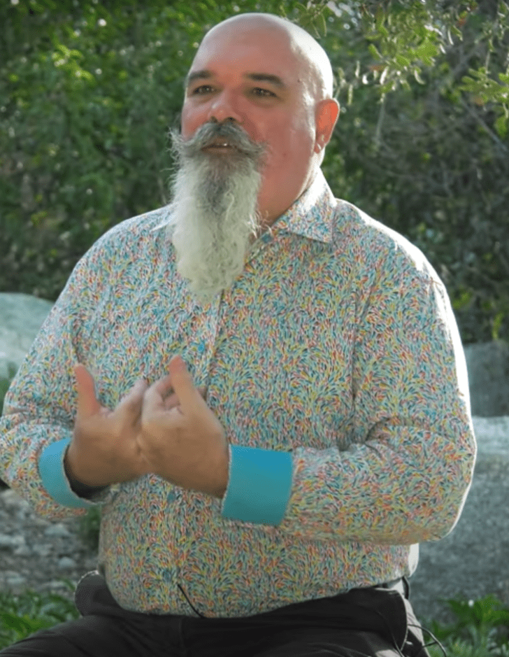 brian keely sits outside surrounded by native california plants